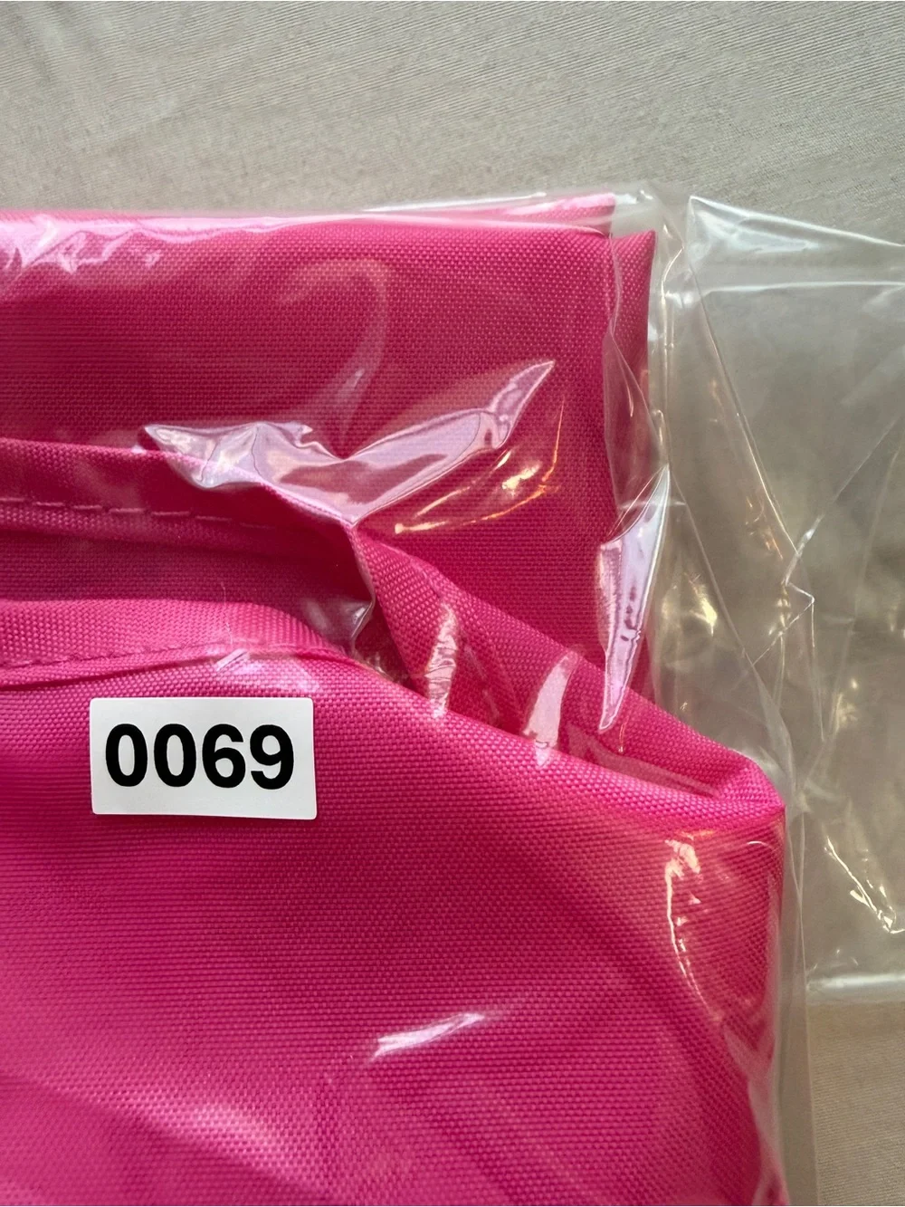 kate spade hot pink garment bag with gold logo